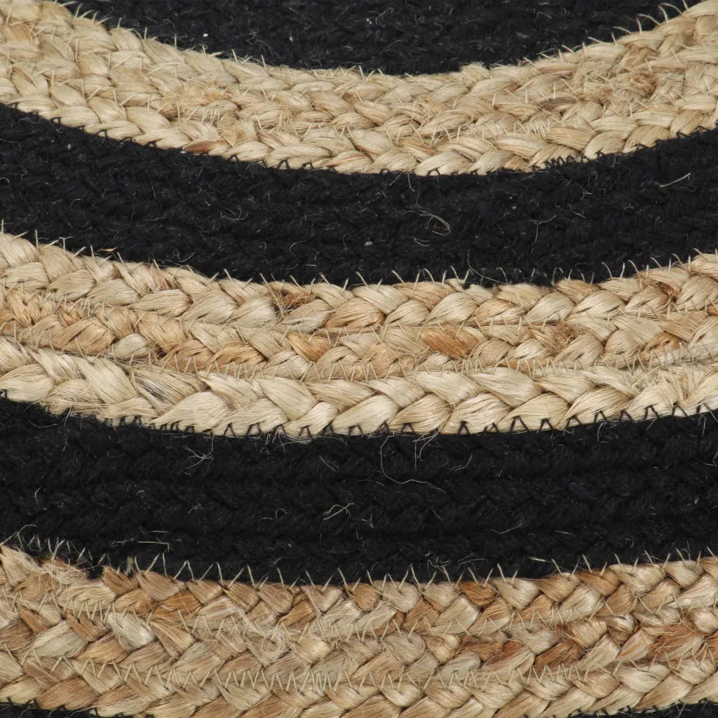 Un Pouffe Repose Pieds artisanal en toile de jute et aux rayures noires.